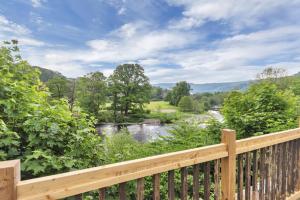 a view of a river from a wooden deck at White Waters Hotel & Spa Llangollen in Llangollen +55 photos