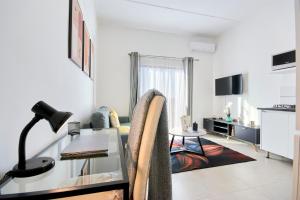 a living room with a glass table and a couch at The Base Apartment in Johannesburg