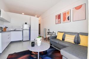 a living room with a couch and a table at The Base Apartment in Johannesburg