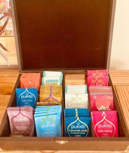 a wooden box filled with different colored candles at Newry Premium B&B in Newry
