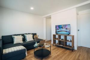 a living room with a couch and a tv at Almare Suites - Aguadulce Vistas al mar in Aguadulce