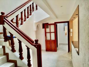 a hallway with a staircase and a wooden door at Maison Traditionnelle à 10mnt de la plage in Agadir +3 photos