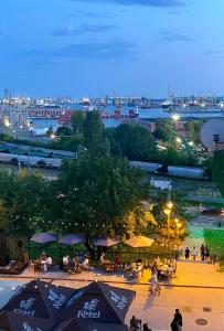 a group of people sitting in a park at night at Old Town Apartment in Constanţa