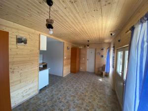 a hallway of a house with a wooden ceiling at Pensiunea Blue House in Vadu
