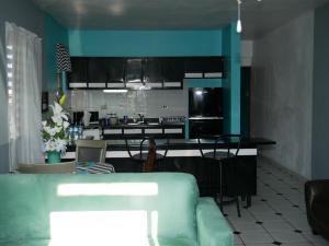 a kitchen with a couch and a table in a room at Labadie Apartment in Aguadilla