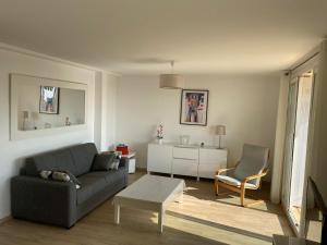 a living room with a couch and a table at VUE MER - Appartement T2 in Cannes