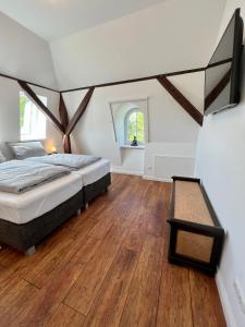 a bedroom with a bed and a wooden floor at Wohnung im Schloss in Todendorf