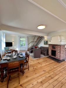 a living room with a table and a fireplace at Wohnung im Schloss in Steinburg