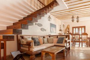a living room with a couch and a staircase at Waterlovers Beach Resort in Diani Beach