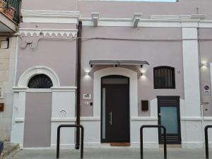 a white building with a black door on the side at MIA GUEST ROOM in Triggiano