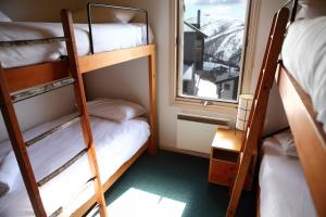 a bunk bed room with two bunk beds and a window at Timbertop in Mount Hotham