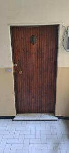 a wooden door in a room with a tile floor at World movida in Sanremo +2 photos