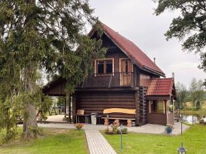 a log cabin with a bench in front of it at Brīvdienu māja Straumēni in Pāle