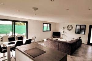 a living room with a couch and a table at Maison in Saint-Léonard
