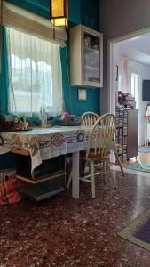 a kitchen with a table and chairs in a room at cozy διαμέρισμα με υπέροχη θέα ! in Athens