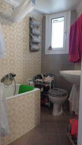 a bathroom with a toilet and a tub and a sink at cozy διαμέρισμα με υπέροχη θέα ! in Athens +49 photos