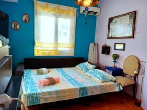 a bedroom with a bed with two pillows on it at cozy διαμέρισμα με υπέροχη θέα ! in Athens