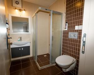 a bathroom with a toilet and a sink and a shower at Seymen Otel in Kizkalesi +98 photos