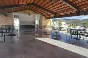 a patio with tables and chairs in a building at Aztec Penthouse in Ensenada