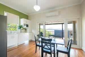 a kitchen and dining room with a table and chairs at Victoria Street Apartments in Grafton