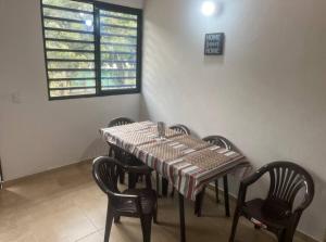 a table and chairs in a room with a window at Apartamento campestre 101 in Ibagué +8 photos