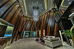 um átrio com um sofá e um candelabro em Cayan Tower Dubai Marina - By Home Of Choice no Dubai