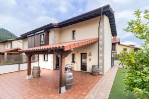 an exterior view of a house with a patio at El capricho de Laio in Pesués