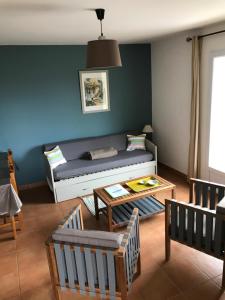 a living room with a couch and a table at Vistamare Locations avec Piscine saint florent in Saint-Florent