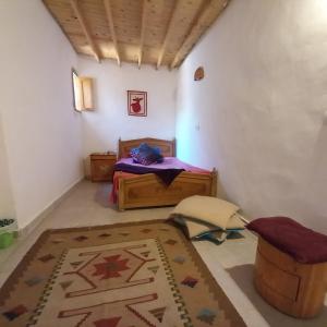 a bedroom with a bed and a rug in a room at Special cozy studio assala in Dahab