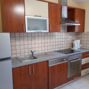a kitchen with a sink and a microwave at Antica Borić 139 in Lopar