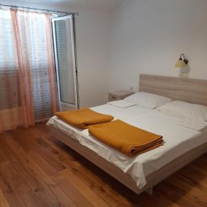a bedroom with a bed with two blankets on it at Antica Borić 139 in Lopar