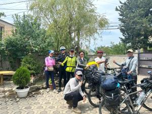 a group of people posing for a picture with their bikes at Guesthouse TEA in Kutaisi