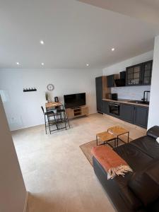 un soggiorno con divano e cucina di Ferienwohnung Kunterbunt a Messkirch