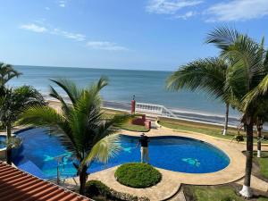a man standing next to a swimming pool next to the beach at En el Mar in Nueva Gorgona