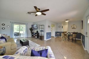 a living room with a couch and a ceiling fan at The Purple Palm House in Sebring
