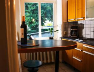 a bottle of wine sitting on a counter in a kitchen at Central lägenhet in Karlskrona