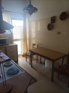 a kitchen with a table and a table and a dining room at Athanasia's Apartments in Nerátza +11 photos