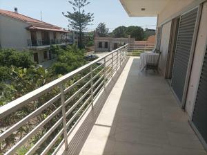 a balcony of a house with a white railing at Athanasia's Apartments in Nerátza