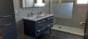 a bathroom with a sink and a mirror at Maison 3 chambres in Parentis-en-Born