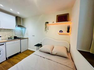 a small kitchen with a bed in a room at Mini - Tout petit mais cozy ! in Brignoles