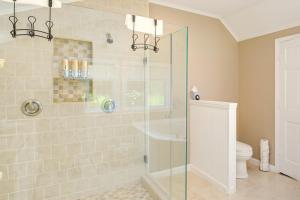 a bathroom with a glass shower with a toilet at Bayfront Steuben Home with Screened Porch and Fire Pit in Steuben +16 photos