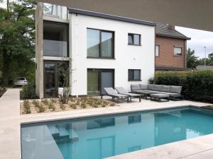 a house with a swimming pool in front of it at Huis Vanellus in Hasselt