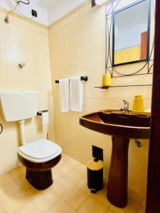 a bathroom with a toilet and a sink at Caparica Terrace Beach Apartment in Costa da Caparica +15 photos
