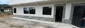 a house with two windows and a door at Apartamento campestre 101 in Ibagué