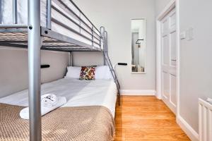 a small bedroom with a bunk bed and a staircase at West Beach 3 - Portrush by the Sea in Portrush