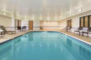 a large swimming pool with chairs and tables at Hampton Inn Chicago-Tinley Park in Tinley Park