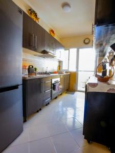 a kitchen with stainless steel appliances and a tile floor at Cozy family appartement in Tangier