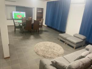 a living room with a couch and a table and chairs at 宮の宿 in Fujinomiya
