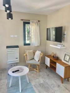 a room with a desk and a chair and a table at BOSQUE LIBERTAD Casa Planta Baja in Mar Azul +12 photos