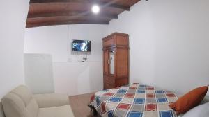 TV a/nebo společenská místnost v ubytování Hotel Suite Central Park Tababela
